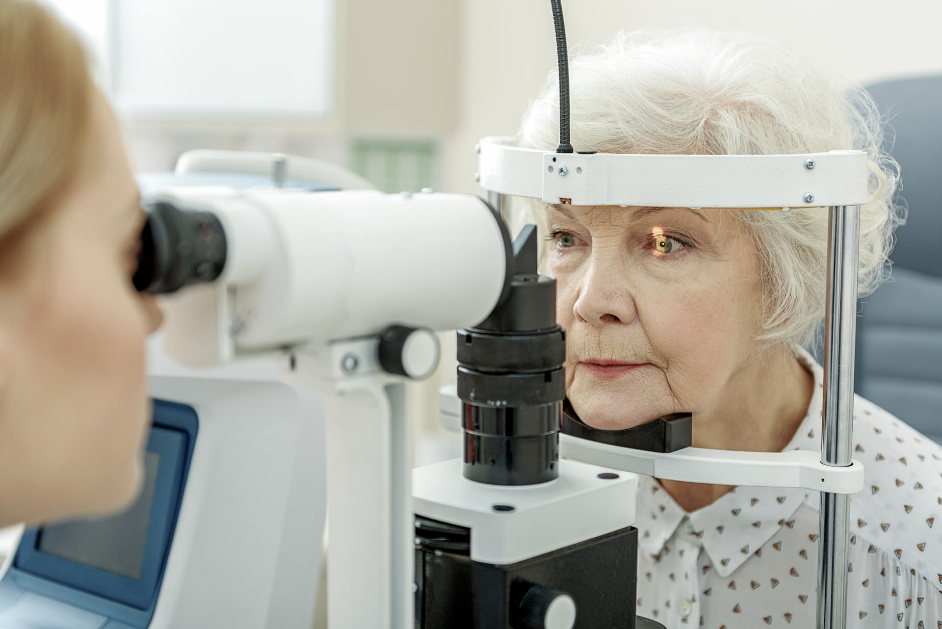 Optometrist using a laser to perform a non-invasive procedure on a patient's eye